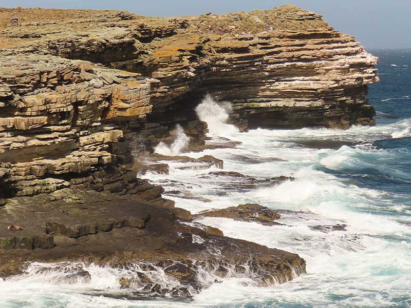 Waves batter the cliffs on Bense Island.